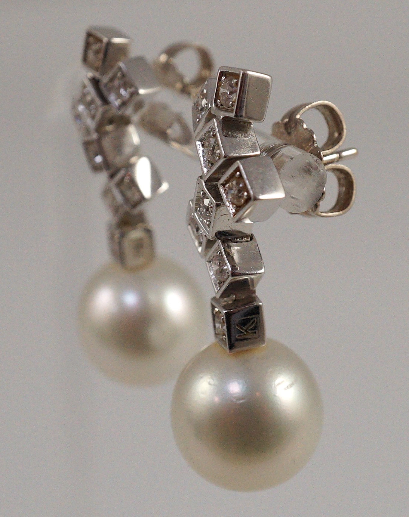 A modern pair of 18ct white gold, single stone South Sea pearl and eight stone diamond cluster set drop earrings, by Kailis